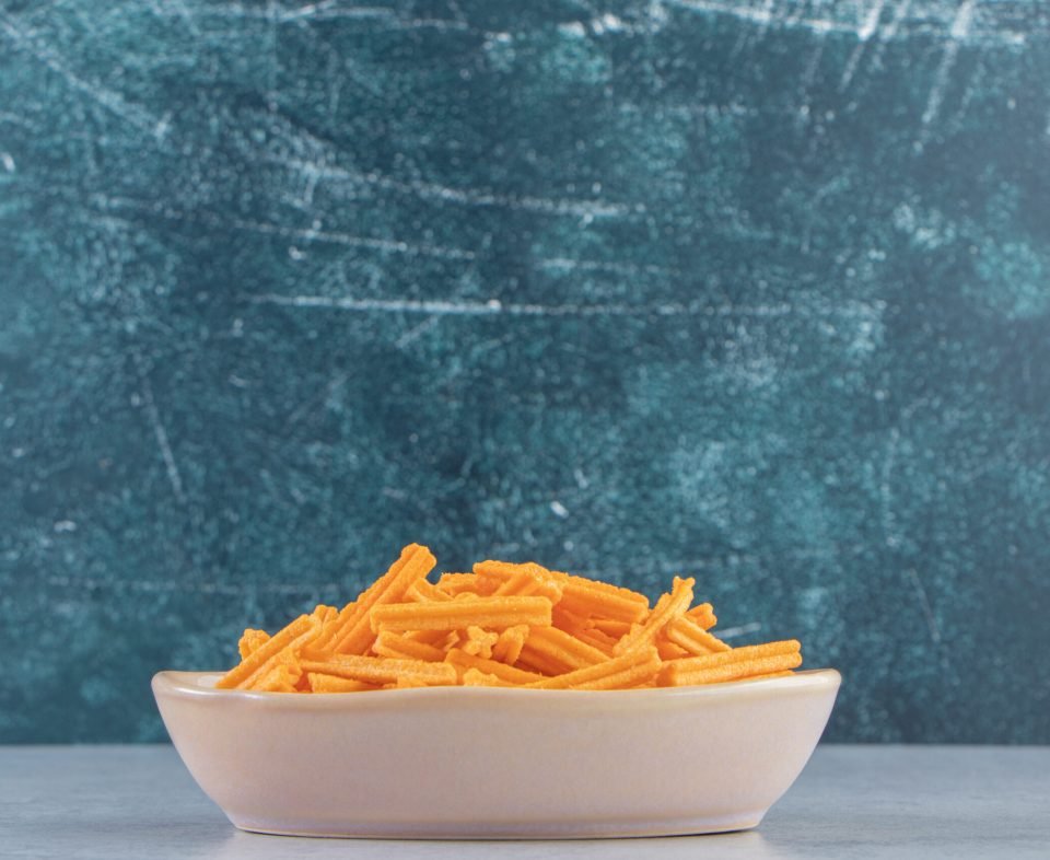Gray bowl of crispy crackers placed on stone background. High quality photo